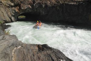 A paddle raft gets splashed while whitewater rafting on the South Fork American River in California with ARTA river trips