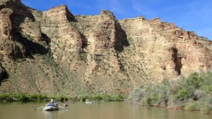 Floating downstream on the river while whitewater rafting on the Green River in Desolation Canyon in Utah with ARTA river trips