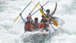 A paddle raft celebrates in Tunnel Chute rapid on the Middle Fork of the American River with ARTA River Trips