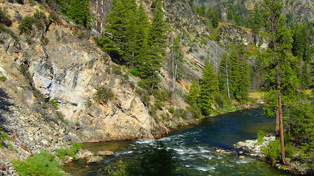Hikers overlook the river while whitewater rafting on the Middle Fork Salmon River in Idaho with ARTA river trips