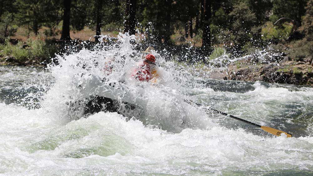 A raft runs Marble Creek rapid while whitewater rafting on the Middle Fork Salmon River in Idaho with ARTA river trips