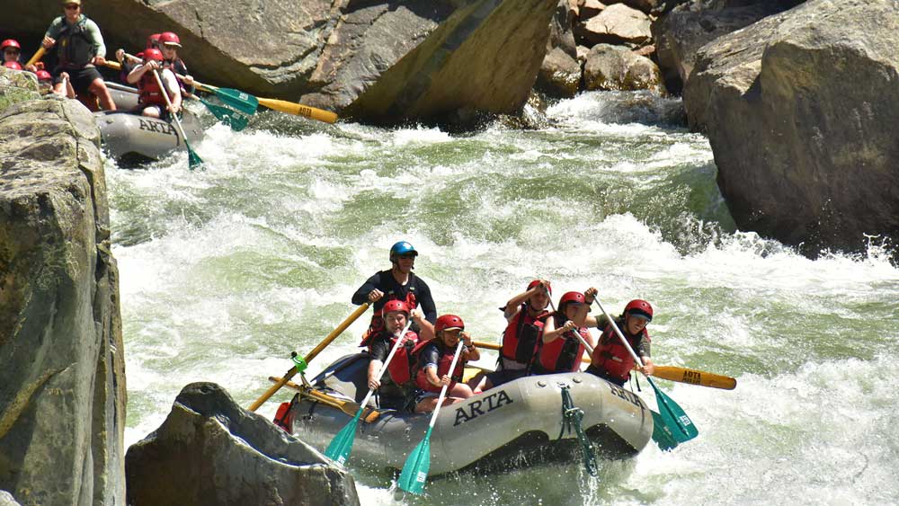 Two oar-paddle rafts in the middle of Split Rock rapid while whitewater rafting on the Merced River in California with ARTA river trips