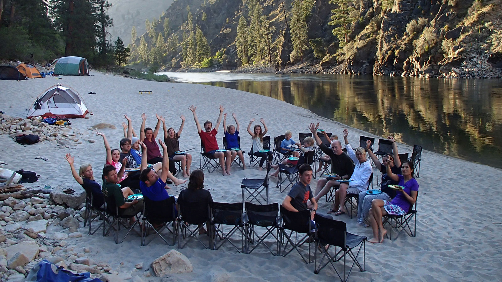 A group enjoys dinner along the banks of the Main Salmon River in Idaho