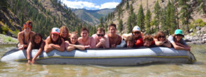 Junior Whitewater School students hanging out on the river