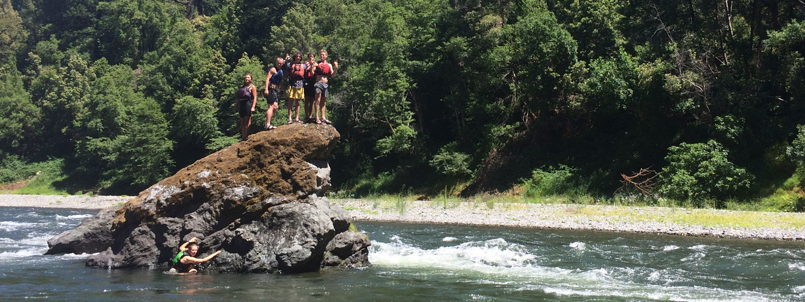 Kids on a rock in the Rogue River in Oregon