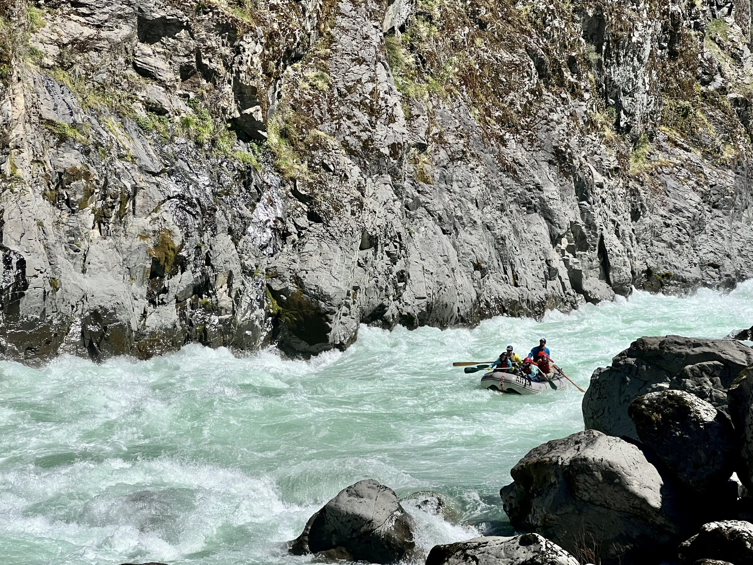 A raft navigated white water on the Illinois river