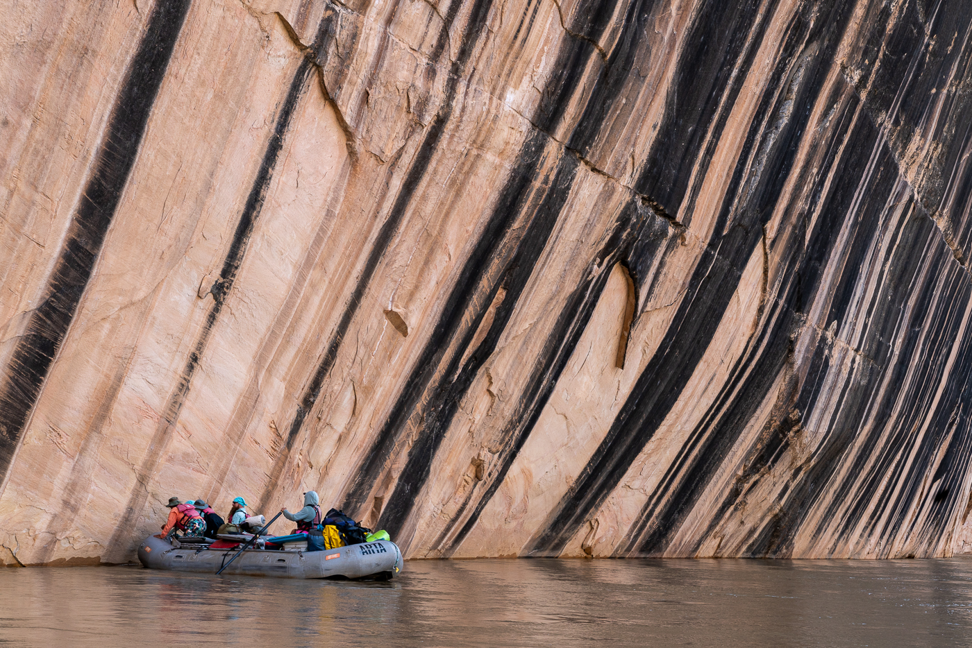 A raft paddles past a scenic rock on the yampa river