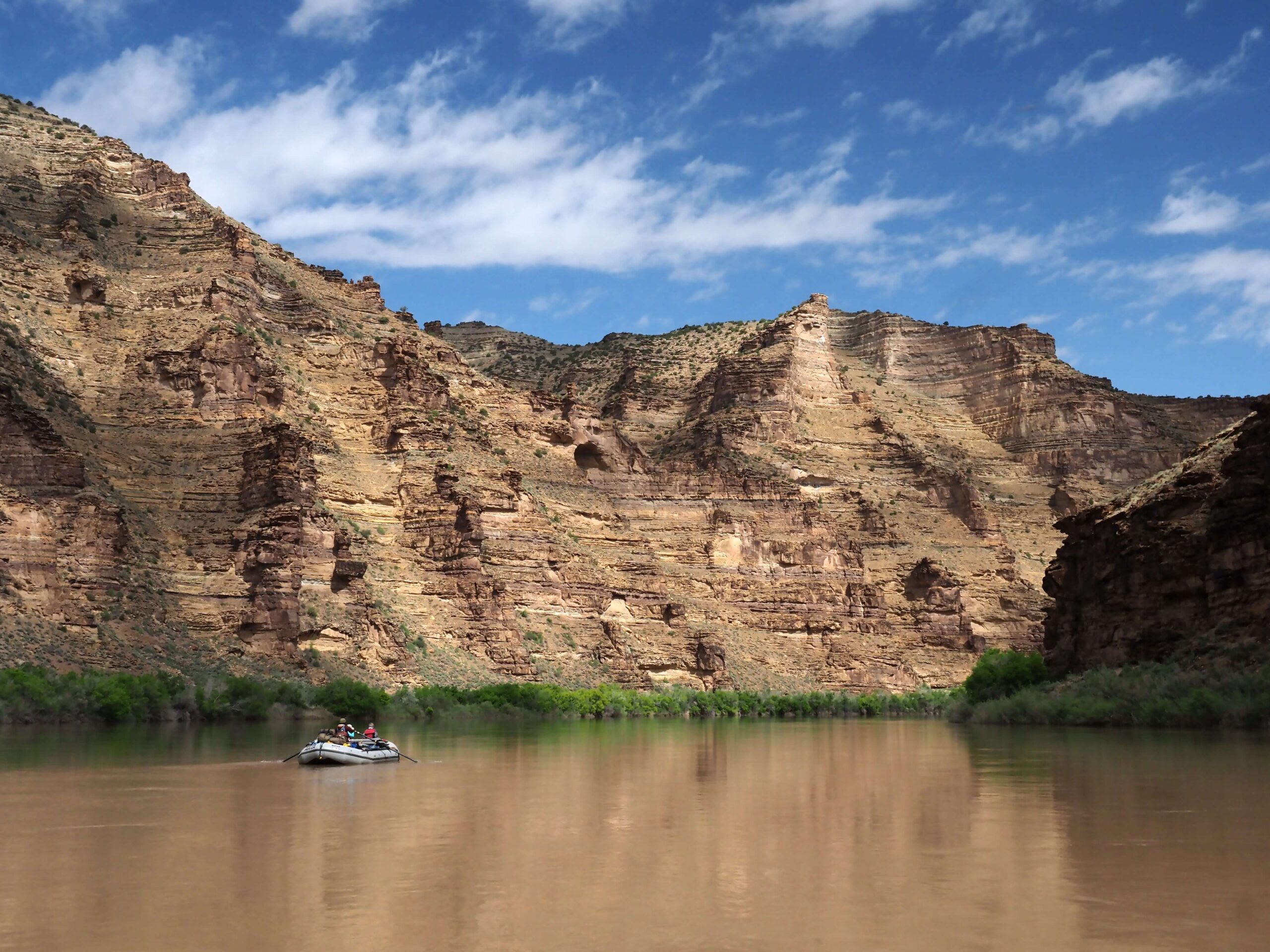 a raft floats on a calm section of river