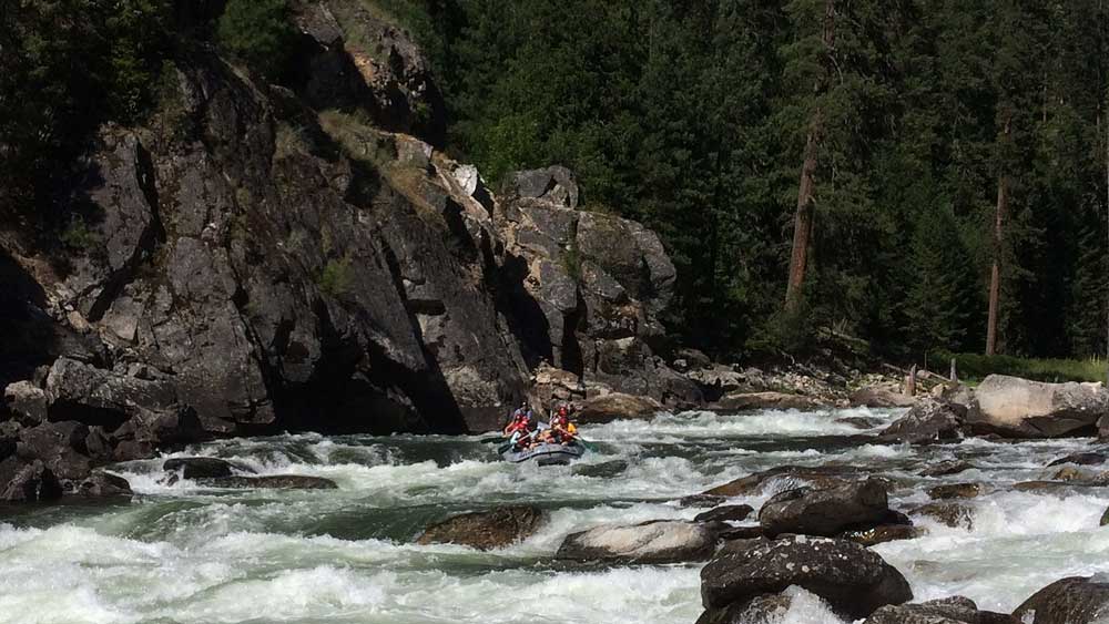 A raft begins paddling through rapids